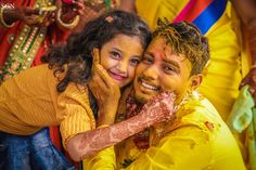 a man and woman are covered in yellow paint while they pose for the camera with other people around them