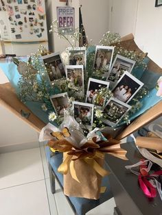 a bouquet of flowers sitting on top of a wooden table next to pictures and ribbons