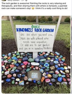 a rock garden with a sign on it that reads, stones kindness's rock garden take me when you need one