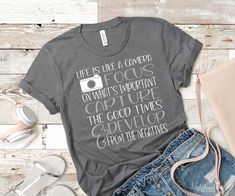 a t - shirt that says life is like a camera on what's important capture the good times and give up from the negatives