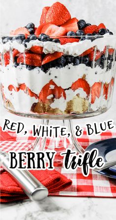 red, white and blue berry trifle in a glass dish on a checkered table cloth