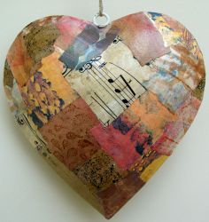 a heart shaped ornament with music notes on it