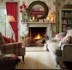 a living room filled with furniture and a fire place under a mirror on the wall