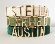 three bracelets with the words stella, iced and austin in gold on them