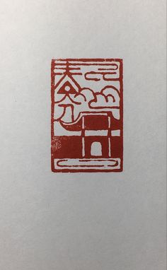 a red and white drawing on top of a piece of paper