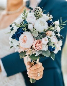 a person holding a bouquet of flowers in their hands