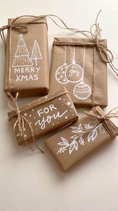 four brown bags with christmas ornaments on them