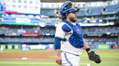 a baseball player is walking on the field