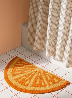 an orange rug sitting on the floor next to a shower