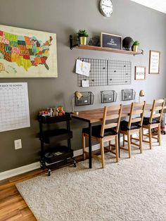 a dining room table and chairs in front of a wall with a map on it