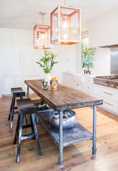 a kitchen with an island and stools in it