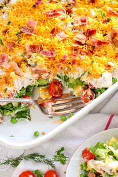 a large casserole dish filled with salad and cheese