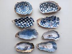 six blue and white plates with designs on them are arranged in a gridded pattern