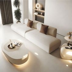 a living room filled with white furniture and lots of lights on the side of the wall