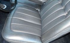 the interior of a car with silver leather seats