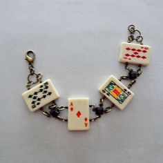 "Fun and novel bracelet design for all the card players and gamblers. Carved bone playing card beads are accented with antique brass metal links and black acrylic cabochons.  The length of the bracelet is 7 1/4\".  Let me know if you need an adjustment on this length and I can do that prior to shipping.  There is a matching antique brass lobster claw closure on the bracelet. All of my jewelry items come boxed, and ribbon tied and tagged for easy gifting." The Card Players, Antique Brass Metal, Bracelets Design, Carved Bone, Bracelet Design, Playing Card, Bead Bracelet, Bracelet Gift, Bracelet Designs