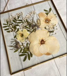 an image of flowers in a frame on the floor