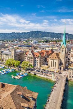 an aerial view of a city with boats in the water