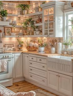 a kitchen filled with lots of white cabinets