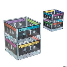 three different colored cassettes stacked on top of each other in acrylic boxes