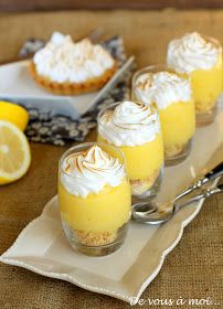 mini lemon pies with whipped cream on top are sitting on a serving platter