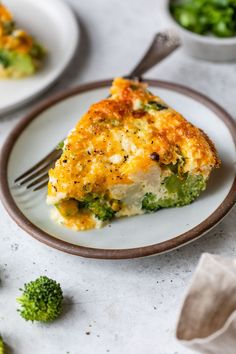 a slice of broccoli and cheese quiche on a plate with a fork