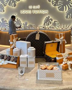 louis vuitton's display in the store is filled with boxes, cookies and pastries