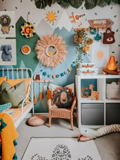 a child's bedroom decorated in orange, blue and green with an animal theme