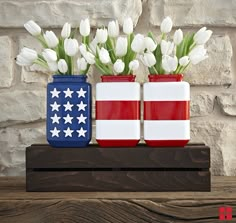 two red, white and blue vases with flowers in them