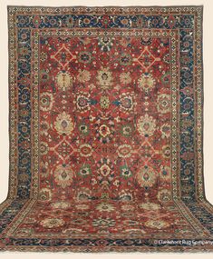 an antique rug with many different colors and designs