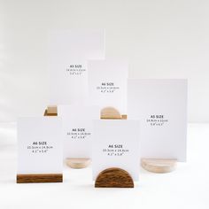 five white cards with wood stand on top of each other in front of a white background