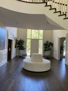 a living room filled with furniture and a spiral staircase