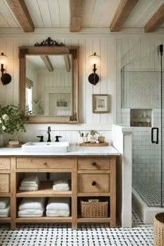 a bathroom with a sink, mirror and shower in it's centerpieces