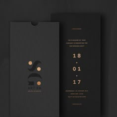 a black and gold wedding card with numbers on it