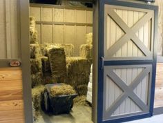 an open barn door with hay in it