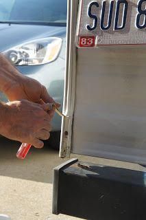 a man is writing on the side of a truck