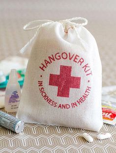 a bag with a red cross on it sitting next to a tube of toothpaste