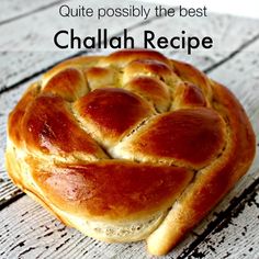 a piece of bread sitting on top of a white wooden table with text overlay that reads, quite possibly the best chalabh recipe