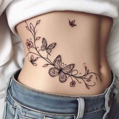 a woman's stomach with flowers and butterflies on it