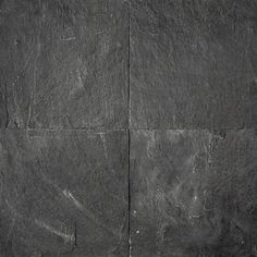 a black slate wall textured with dark gray paint