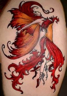 an image of a tattoo on someone's back with red and orange designs,