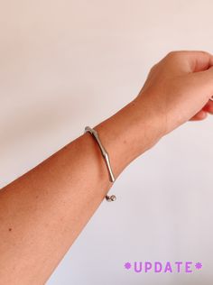 a woman's arm with a bracelet on it and the words update written below