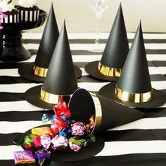 black and gold party hats with candy in them