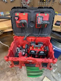 an open tool box filled with tools on top of a table