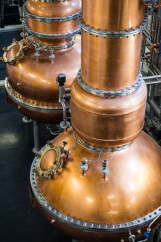 three large metal tanks sitting next to each other