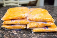 five bags of cheese sitting on top of a counter