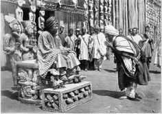 an old black and white photo of people in native american dress standing around with masks on their heads