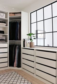 a white closet filled with lots of clothes