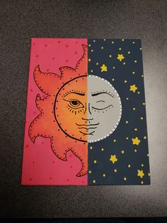 two different colored paper pictures with the same image on them, one has a sun and the other is a moon