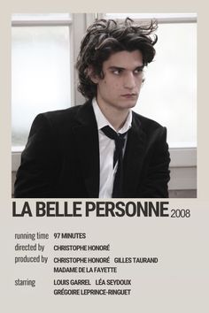 a man in a suit sitting next to a window with the words la belle personne on it